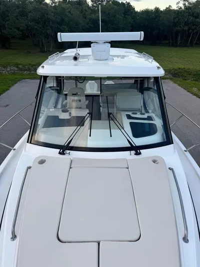  Yacht Photos Pics 2023 Boston Whaler 325 Conquest boat, top view, showcasing sleek design and spacious deck.
