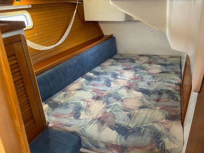 Unbridled Yacht Photos Pics Cozy cabin interior of a 1996 Catalina 42 sailboat with patterned bedding.