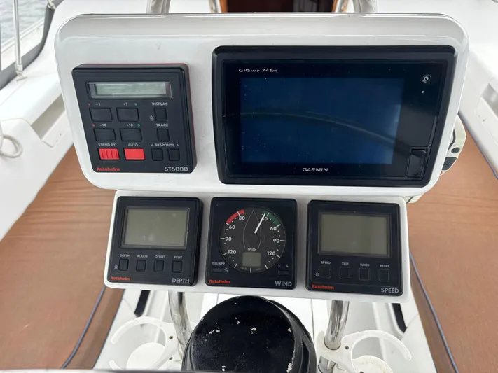 Unbridled Yacht Photos Pics Cockpit navigation instruments on a 1996 Catalina 42 sailboat, featuring Garmin and Raymarine displays.