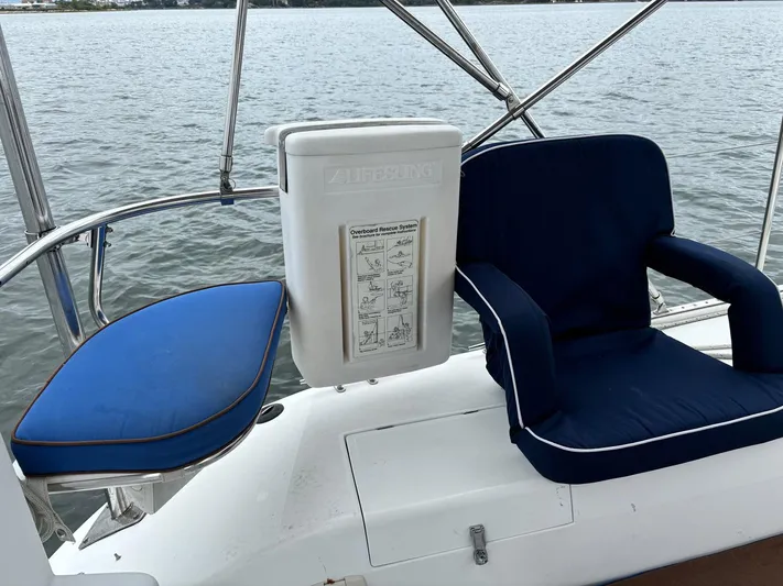 Unbridled Yacht Photos Pics Cockpit seating on a 1996 Catalina 42 sailboat with blue cushions.