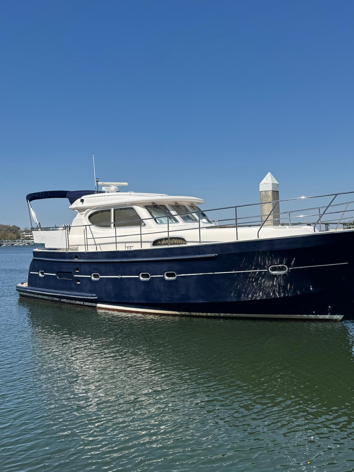 2007 Elling E3 yacht docked on calm water under clear blue sky.