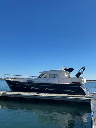Celaeno Yacht Photos Pics Elling E3 2007 yacht docked on calm water under clear blue sky.