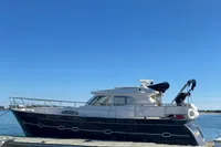 Elling E3 2007 yacht docked on calm water under clear blue sky.