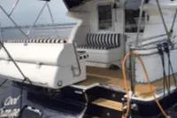 2007 Elling E3 yacht with striped seating and canopy, docked on calm water.