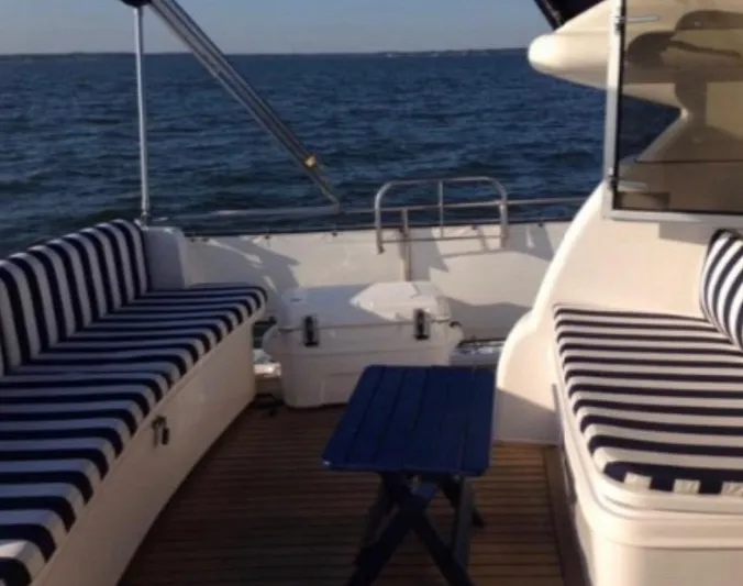Celaeno Yacht Photos Pics Deck of 2007 Elling E3 yacht with striped seating and ocean view.