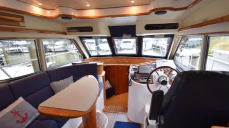 Celaeno Yacht Photos Pics Luxurious 2007 Elling E3 yacht interior with plush seating and modern helm.