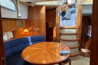 Luxurious interior of 2007 Elling E3 yacht with elegant wood finishes and cozy seating area.