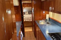 Luxurious 2007 Elling E3 yacht interior with sleek wood finishes and modern kitchen amenities.