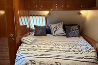 Luxurious bedroom interior of 2007 Elling E3 yacht with elegant bedding and wood finishes.