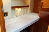 2007 Elling E3 yacht interior cabin with single bed and wooden cabinetry.