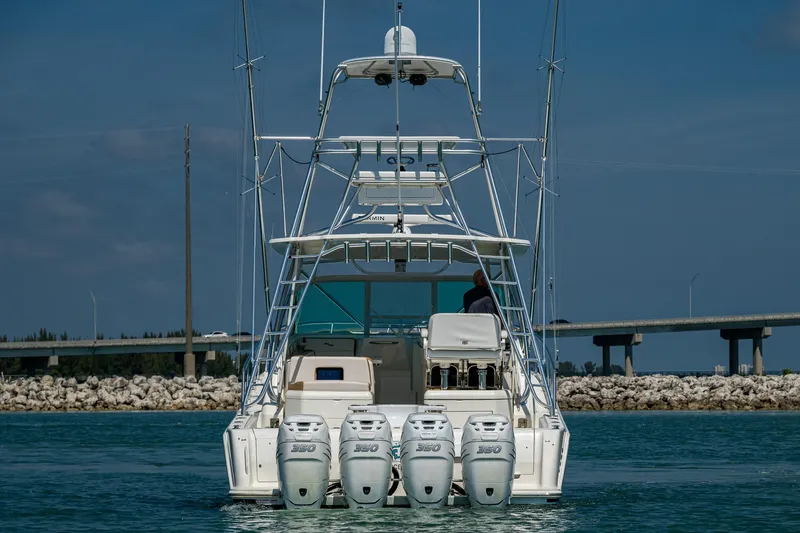 Refit 2018 - Reel Deal Yacht Photos Pics 2012 SeaVee 43 Express boat with four engines on the water, rear view.