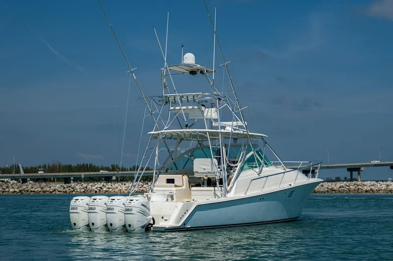 Refit 2018 - Reel Deal Yacht Photos Pics 2012 SeaVee 43 Express boat with four outboard engines on calm water.