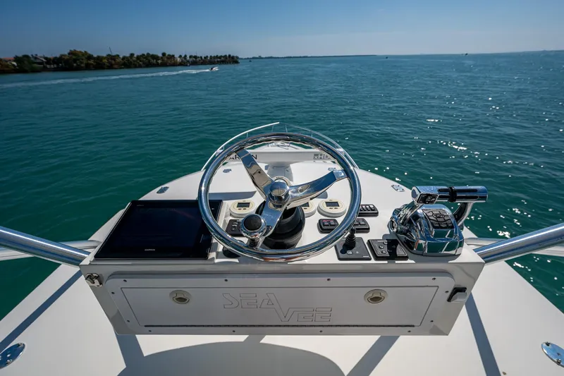 Refit 2018 - Reel Deal Yacht Photos Pics 2012 SeaVee 43 Express helm with ocean view, featuring steering wheel and controls.