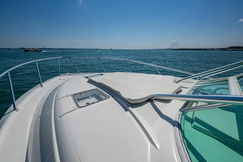 Refit 2018 - Reel Deal Yacht Photos Pics 2012 SeaVee 43 Express yacht deck with ocean view under clear blue sky.