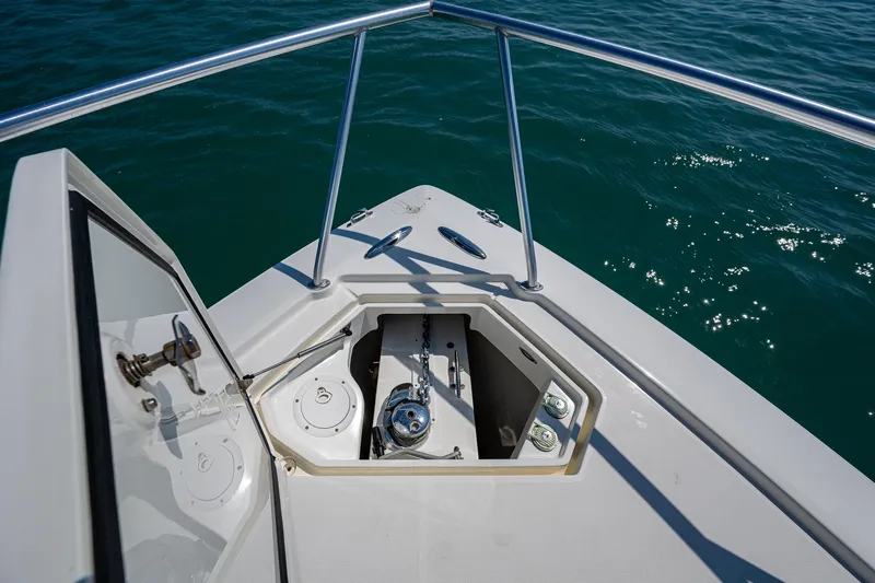 Refit 2018 - Reel Deal Yacht Photos Pics Bow of 2012 SeaVee 43 Express boat with open anchor hatch on calm water.