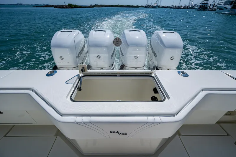 Refit 2018 - Reel Deal Yacht Photos Pics 2012 SeaVee 43 Express boat with four powerful outboard engines on open water.