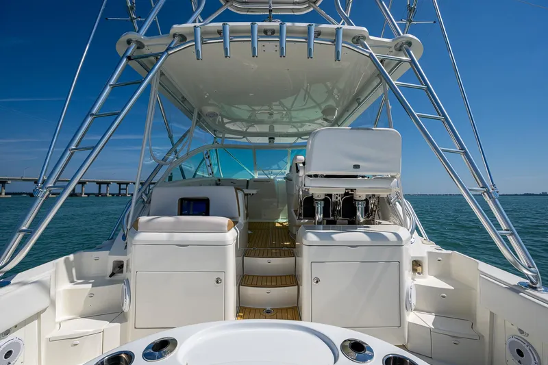 Refit 2018 - Reel Deal Yacht Photos Pics 2012 SeaVee 43 Express boat with spacious deck and seating, under clear blue sky.