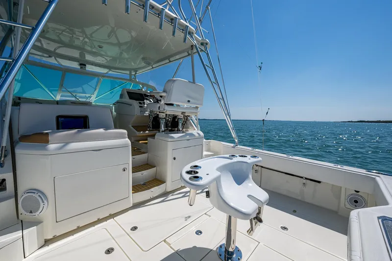 Refit 2018 - Reel Deal Yacht Photos Pics 2012 SeaVee 43 Express boat interior with ocean view, featuring helm and seating area.