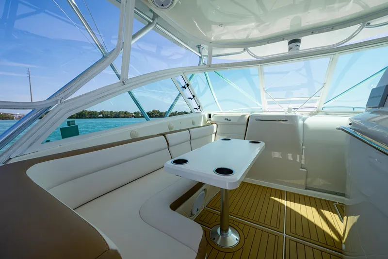 Refit 2018 - Reel Deal Yacht Photos Pics 2012 SeaVee 43 Express boat interior with seating and table, featuring panoramic windows.