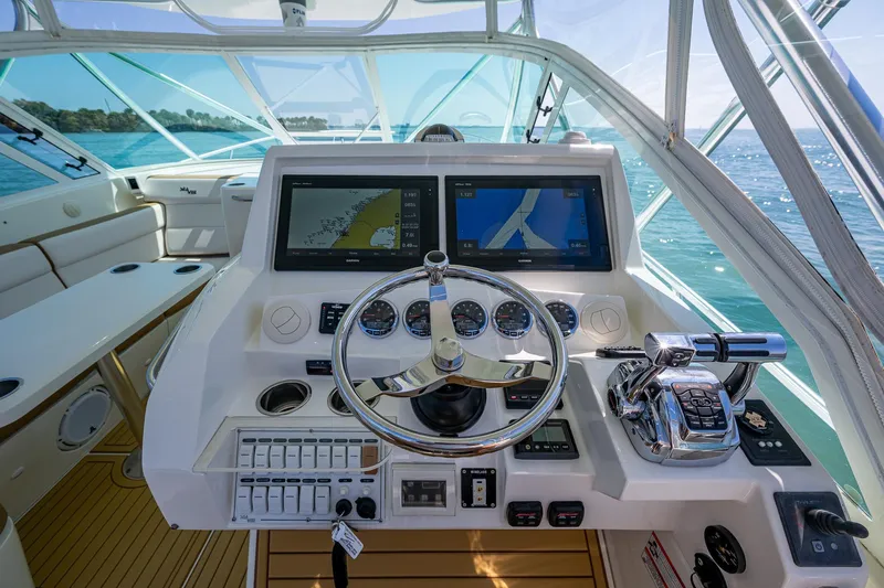 Refit 2018 - Reel Deal Yacht Photos Pics 2012 SeaVee 43 Express helm with dual navigation screens and modern controls on open water.