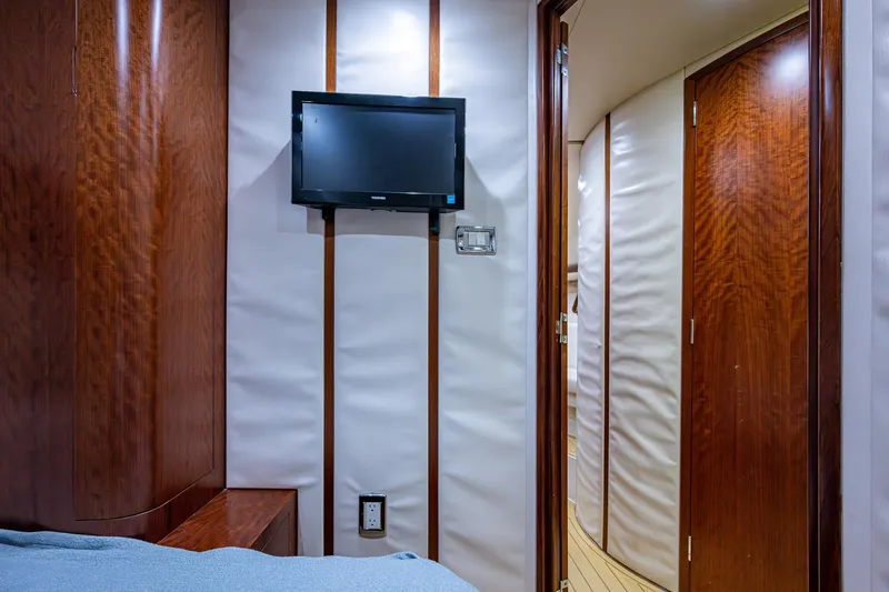 Refit 2018 - Reel Deal Yacht Photos Pics Interior of 2012 SeaVee 43 Express yacht with TV and wooden paneling.