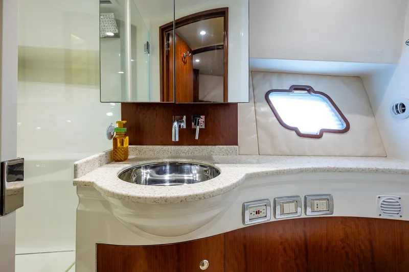 Refit 2018 - Reel Deal Yacht Photos Pics Luxurious bathroom interior of 2012 SeaVee 43 Express yacht with modern fixtures.