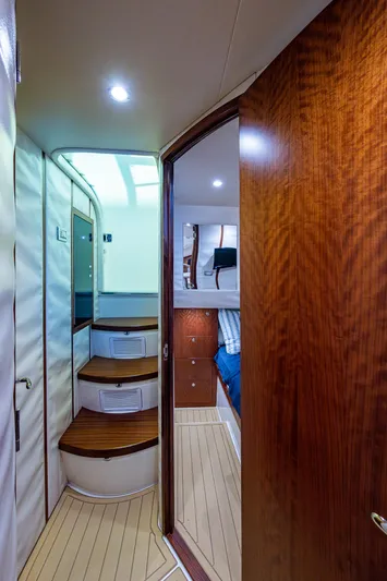 Refit 2018 - Reel Deal Yacht Photos Pics Interior view of 2012 SeaVee 43 Express yacht, featuring wooden steps and modern cabin design.