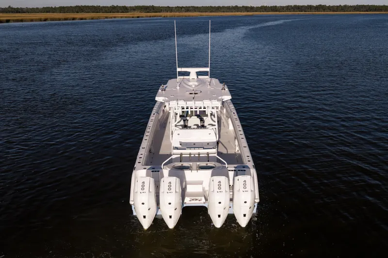  Yacht Photos Pics 2024 Invincible 40 Catamaran on calm water, rear view with four engines.