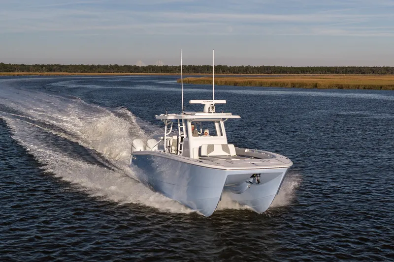  Yacht Photos Pics 2024 Invincible 40 Catamaran cruising on open water, showcasing sleek design and performance.