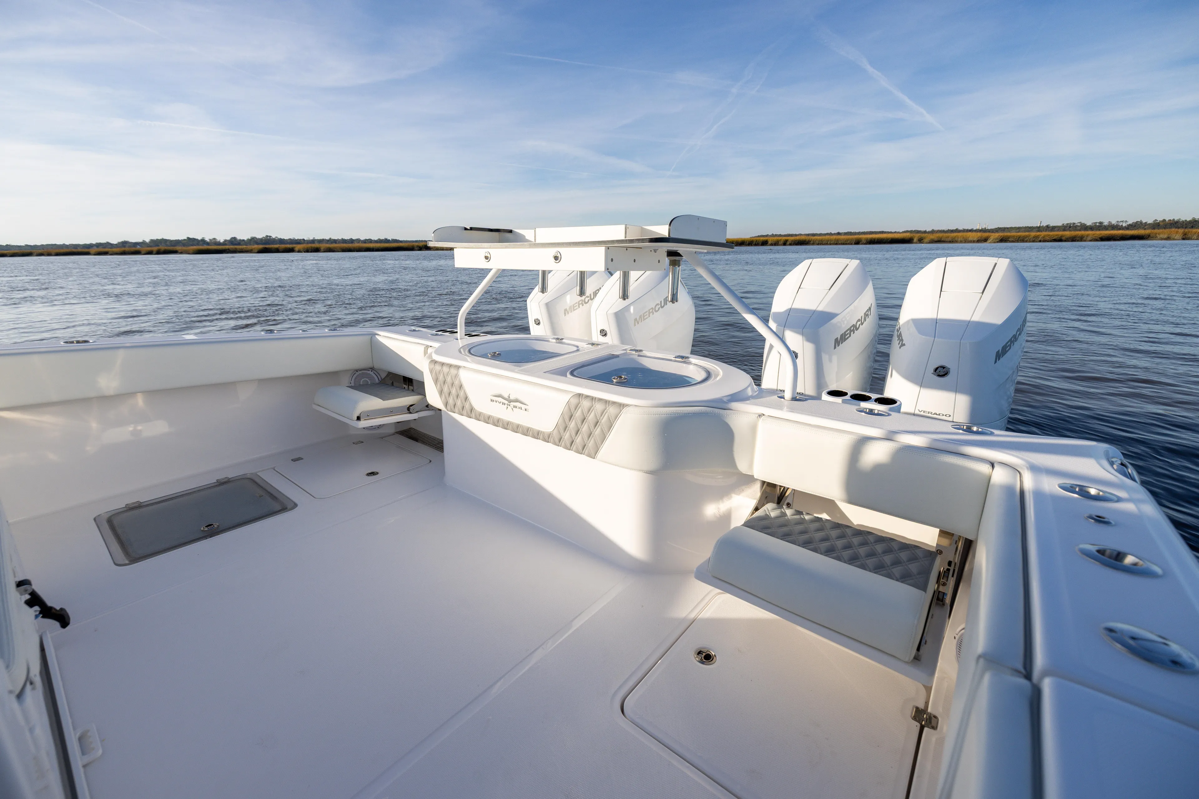  Yacht Photos Pics 2024 Invincible 40 Catamaran boat deck with dual engines on calm water.