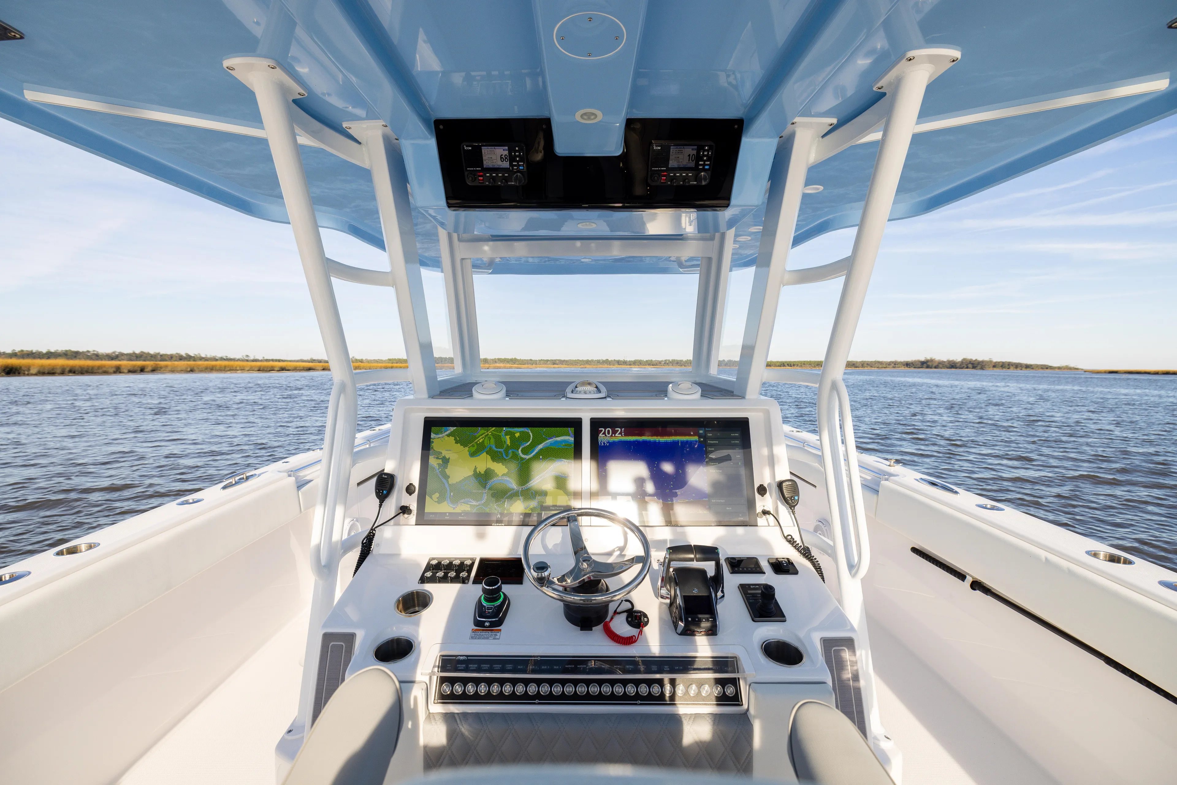  Yacht Photos Pics 2024 Invincible 40 Catamaran helm with dual displays on open water.