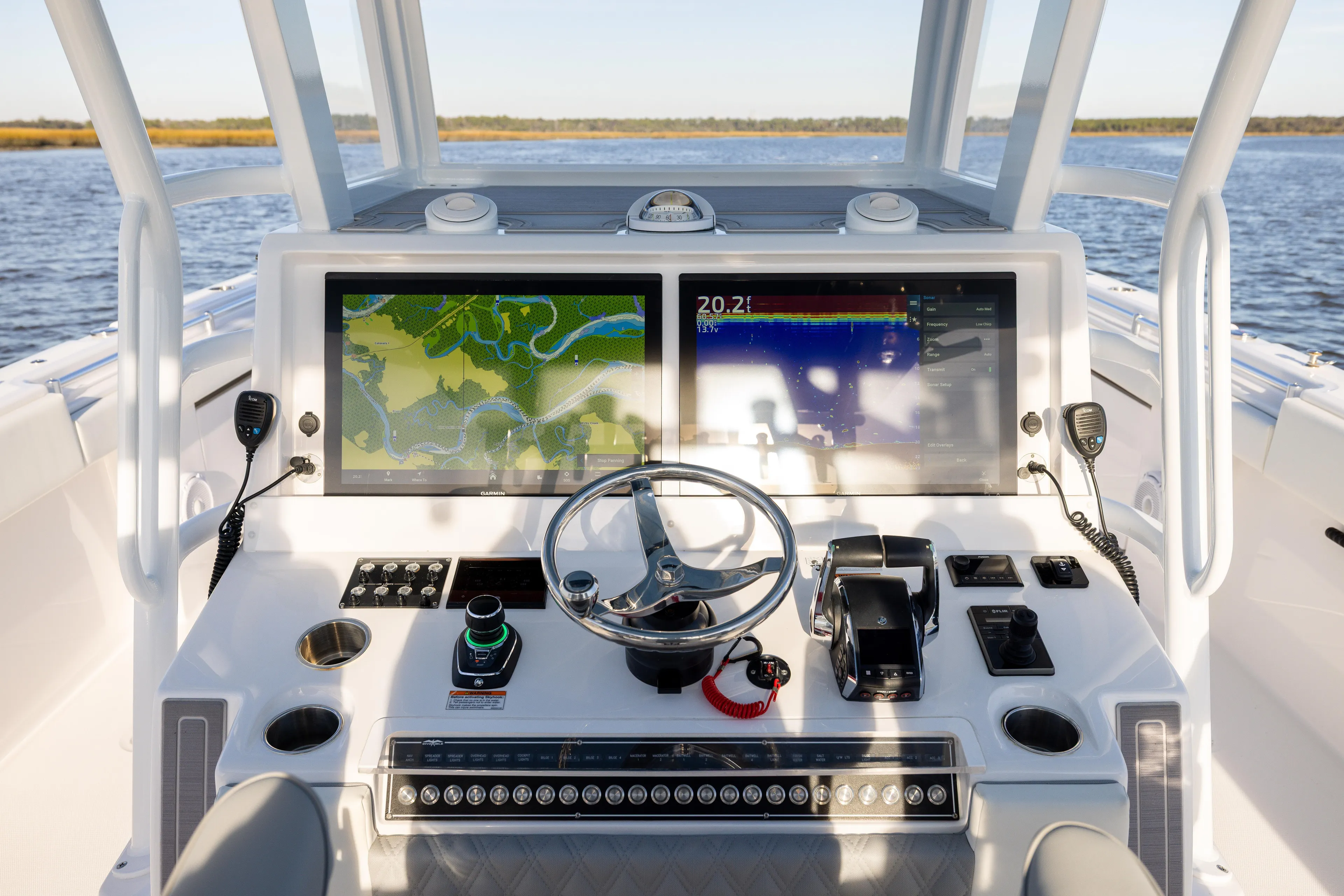  Yacht Photos Pics 2024 Invincible 40 Catamaran helm with dual navigation screens and steering wheel.