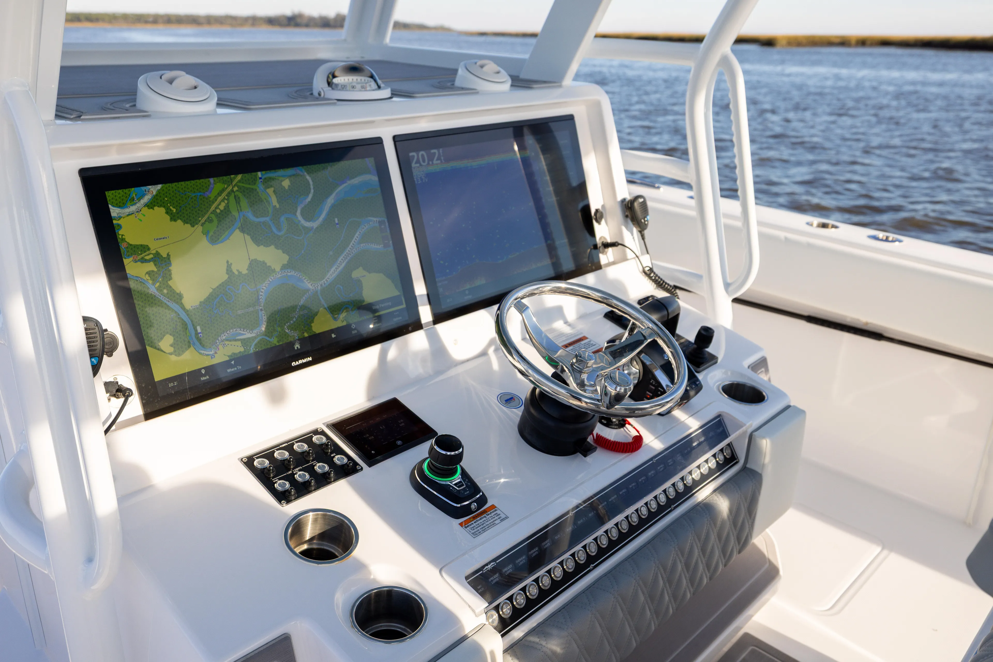  Yacht Photos Pics 2024 Invincible 40 Catamaran helm with dual navigation screens and steering wheel.