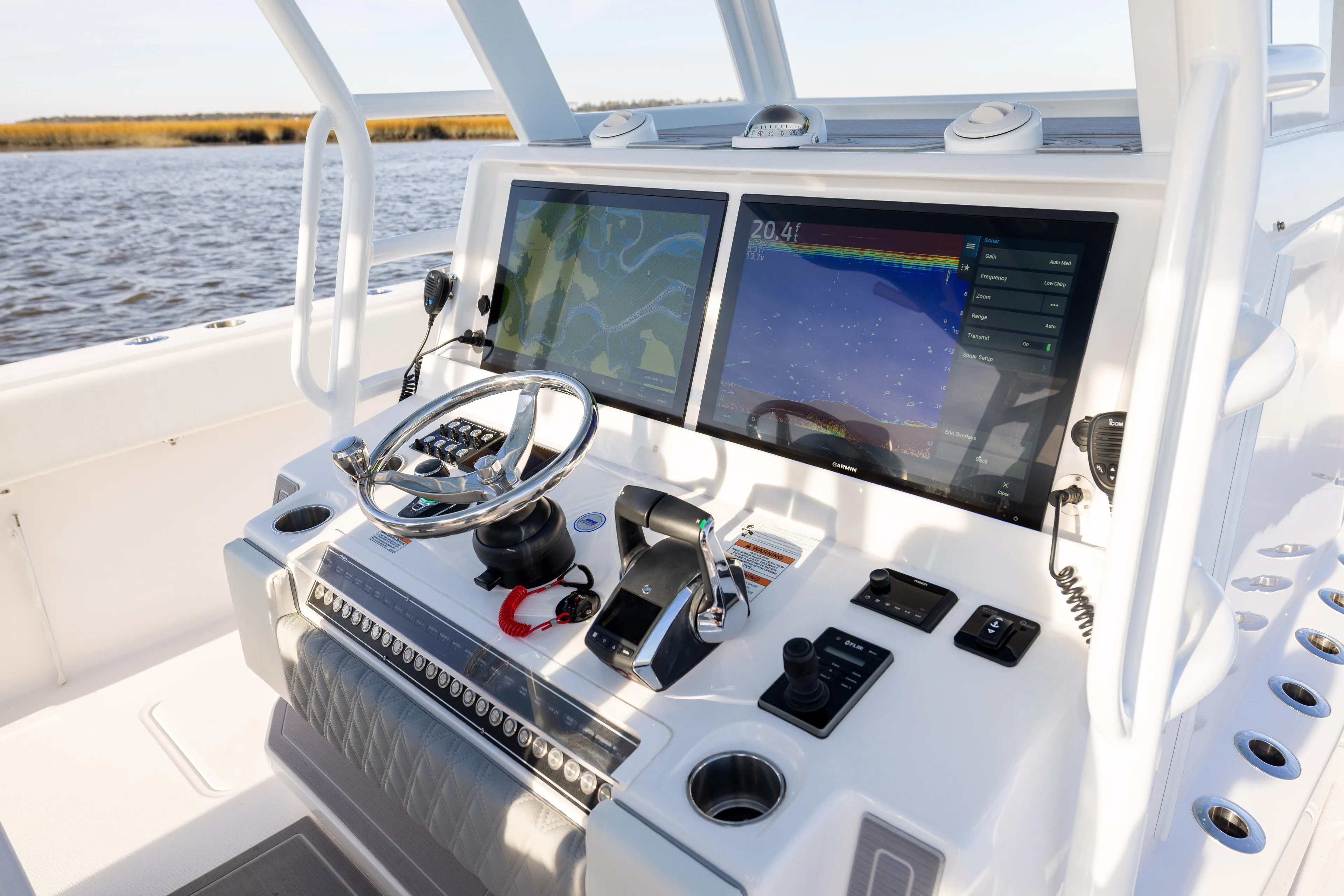  Yacht Photos Pics 2024 Invincible 40 Catamaran helm with dual navigation screens and steering wheel.