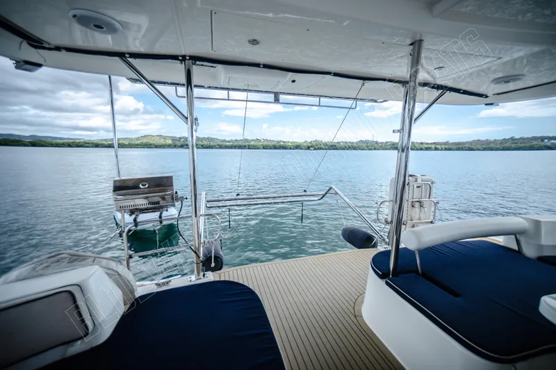 Purple Pearl Yacht Photos Pics Luxurious Leopard 48 yacht deck with seating, grill, and scenic water view, 2015 model.