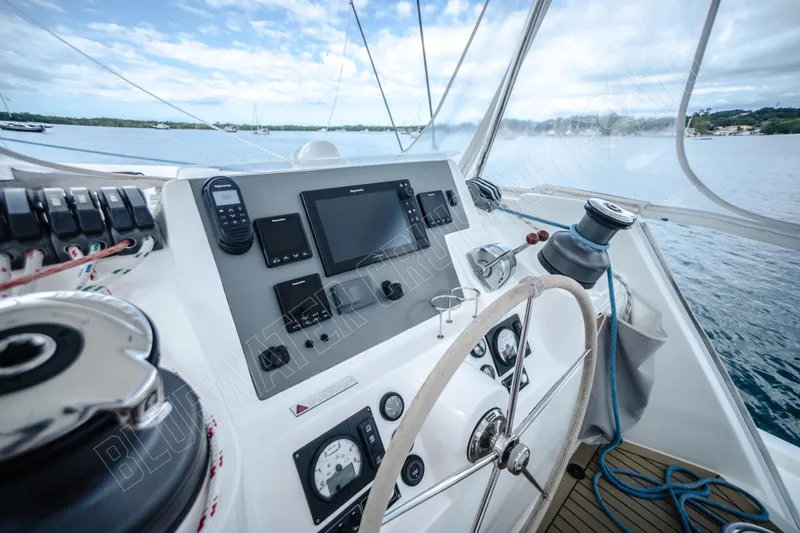 Purple Pearl Yacht Photos Pics Helm of 2015 Leopard 48 yacht with navigation equipment and steering wheel.