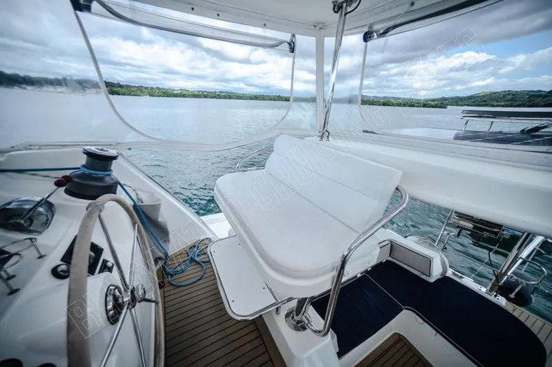 Purple Pearl Yacht Photos Pics Luxurious 2015 Leopard 48 yacht cockpit with steering wheel and seating, overlooking serene waters.