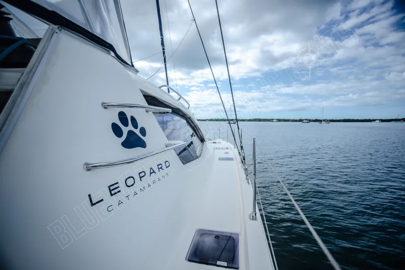 Purple Pearl Yacht Photos Pics 2015 Leopard 48 catamaran sailing on calm waters under a cloudy sky.