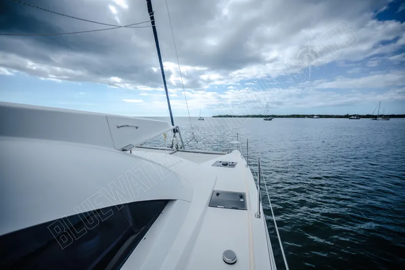 Purple Pearl Yacht Photos Pics 2015 Leopard 48 yacht on calm waters under a cloudy sky.
