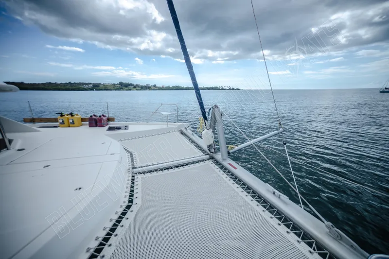 Purple Pearl Yacht Photos Pics Catamaran deck view on Leopard 48, 2015 model, overlooking calm sea and cloudy sky.