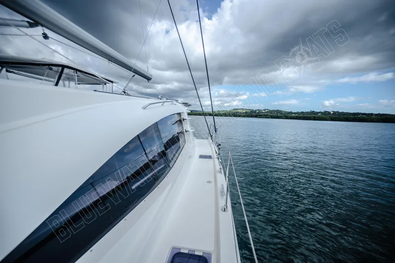 Purple Pearl Yacht Photos Pics 2015 Leopard 48 yacht sailing on calm waters under cloudy skies.