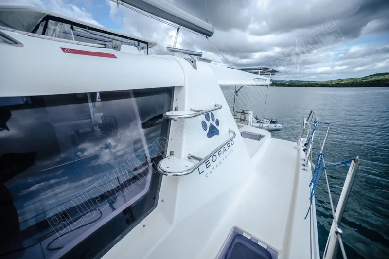 Purple Pearl Yacht Photos Pics 2015 Leopard 48 catamaran on calm water under cloudy sky.