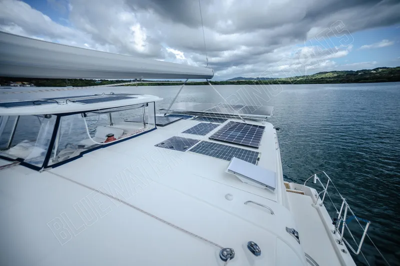 Purple Pearl Yacht Photos Pics 2015 Leopard 48 yacht with solar panels on deck, sailing in calm waters under cloudy skies.
