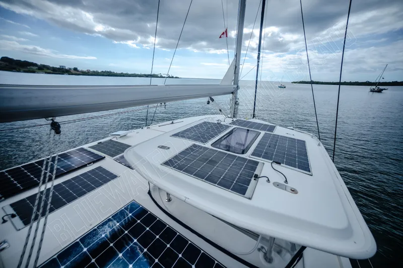 Purple Pearl Yacht Photos Pics Sailing catamaran Leopard 48 (2015) with solar panels on deck, cruising on a calm sea.