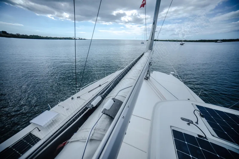 Purple Pearl Yacht Photos Pics Sailing on a 2015 Leopard 48 catamaran, calm waters, cloudy sky, solar panels visible.