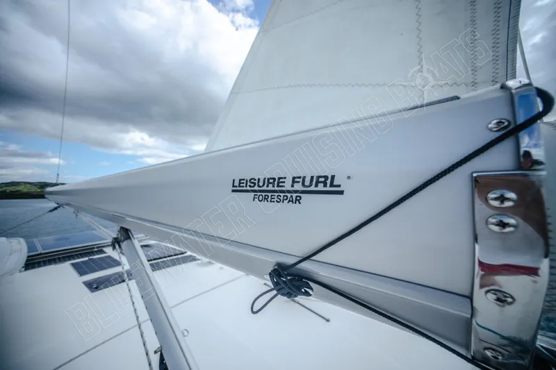 Purple Pearl Yacht Photos Pics Sailboat boom with "Leisure Furl" branding, Leopard 48 model, 2015, under cloudy sky.