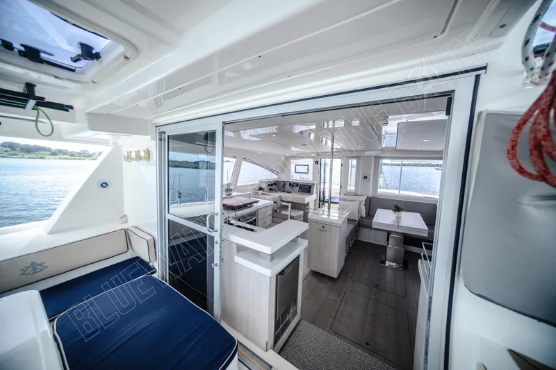 Purple Pearl Yacht Photos Pics Luxurious interior of a 2015 Leopard 48 yacht with modern furnishings and panoramic windows.