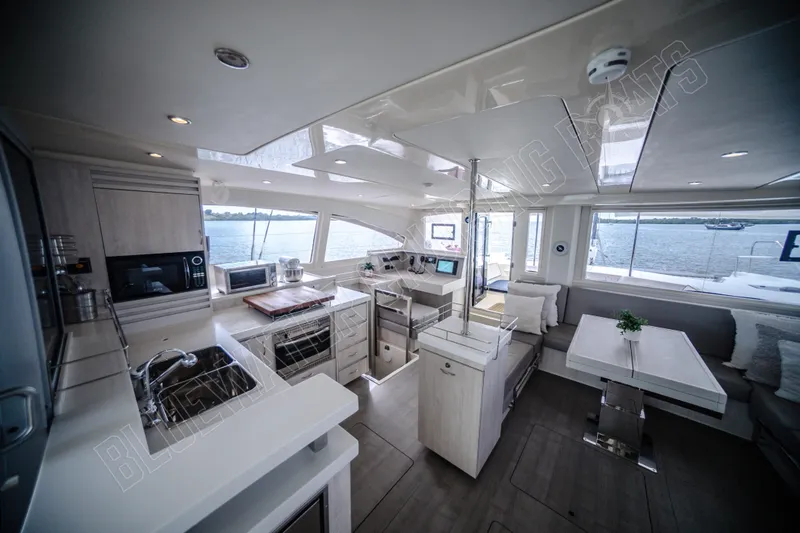 Purple Pearl Yacht Photos Pics Luxurious interior of 2015 Leopard 48 yacht with modern kitchen and dining area.