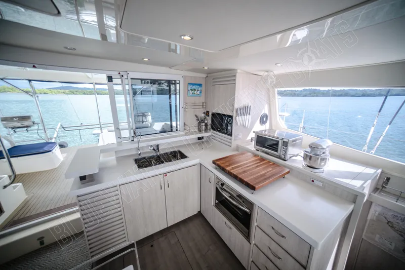 Purple Pearl Yacht Photos Pics Luxurious kitchen interior on 2015 Leopard 48 yacht with ocean view.