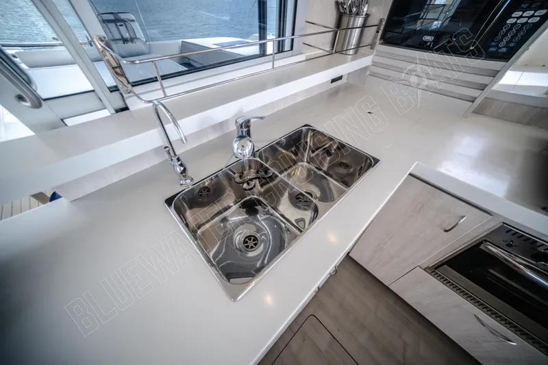 Purple Pearl Yacht Photos Pics Modern kitchen sink area on a 2015 Leopard 48 yacht, featuring stainless steel fixtures.